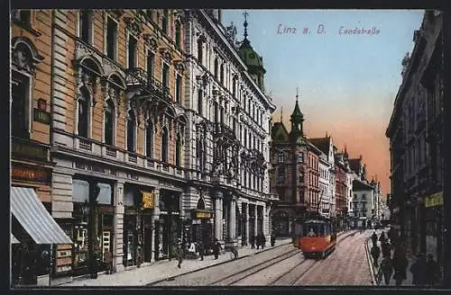 AK Linz a. D., Landstrasse mit Geschäften und Strassenbahn
