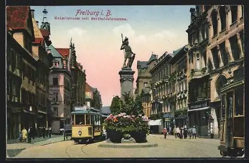 AK Freiburg i. Br., Kaiserstrasse mit Geschäften, Bertholdsbrunnen und Strassenbahn