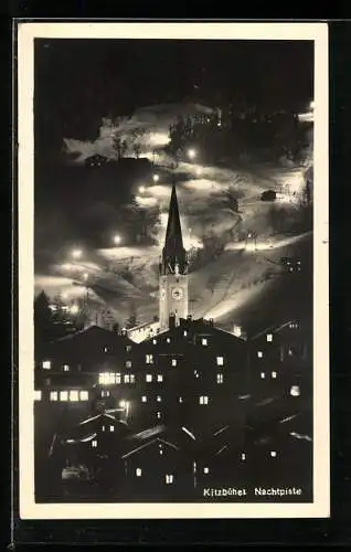 AK Kitzbühel, Kirche und beleuchtete Skipiste bei Nacht