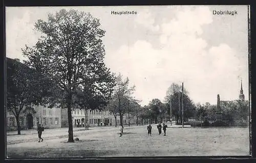 AK Dobrilugk, Hauptstrasse mit Obelisk und Kirchturm