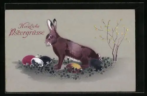 AK Osterhase sitzt mit bunten Eiern auf der Wiese