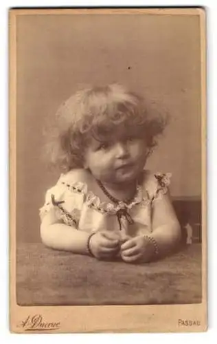 Fotografie A. Ducrue, Passau, niedliches kleines Mädchen Gusti im Kleid mit blonden lockigen Haaren, 1888