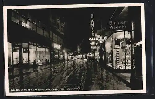 AK Hagen / Westfalen, Hansa-Café und Blumengeschäft Wagner in der Elberfeldstrasse bei Nacht