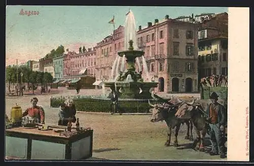 AK Lugano, Ortspartie mit Brunnen und Mann mit Ochsenwagen