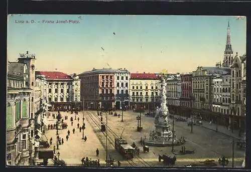 AK Linz a. D., Franz Josef-Platz mit Geschäften und Denkmal, Strassenbahn