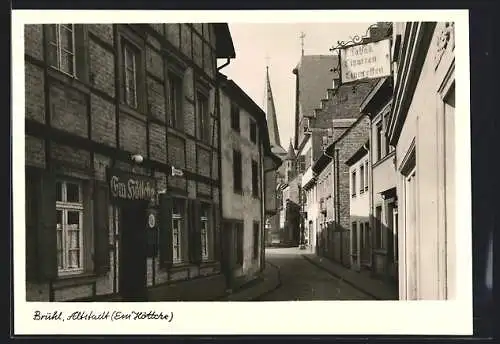 AK Brühl / Rheinl., Strassenpartie am Gasthaus Em Höttche, Blick zur Kirche