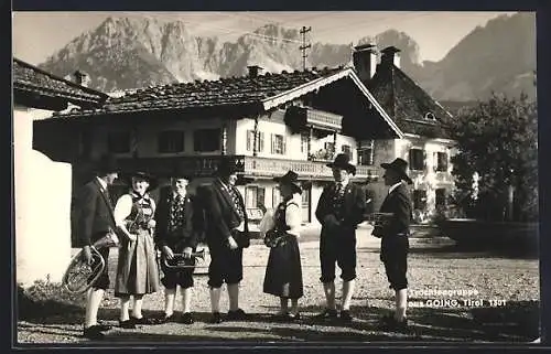 AK Going /Tirol, Trachtengruppe vor einem Wohnhaus