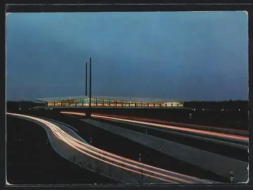 AK Holdorf / Oldb., Autobahn-Brückenrasthaus Dammer Berge bei Nacht