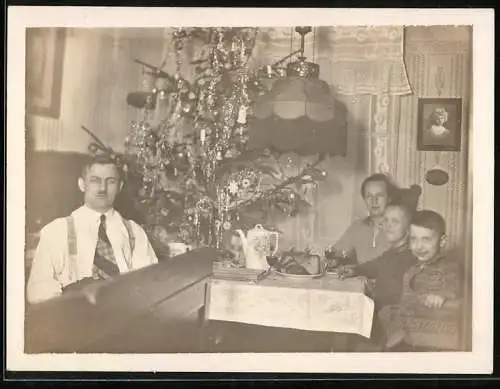 Fotografie Weihnachten, Familie hat sich um den Weihnachtsbaum versammelt