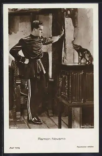 AK Schauspieler Ramon Novarro an einem Vorhang