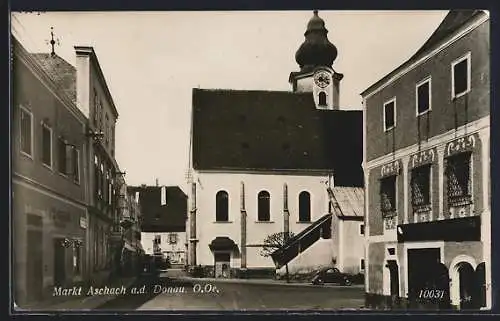 AK Aschach a. d. Donau, Strassenpartie mit Friseurgeschäft und Kirche