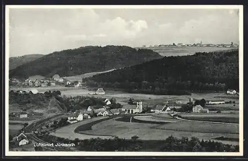 AK Jünkerath, Totalansicht mit Bahnstrecke, Kirche, Ortspanorama in der Ferne