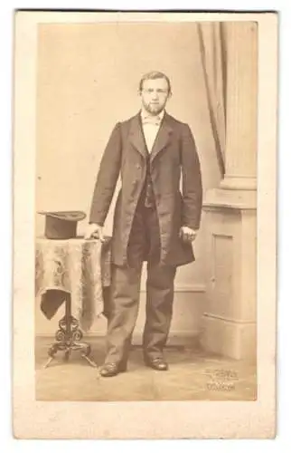 Fotografie F. Grill, Hanau, junger Mann im Anzug nebst Zylinder auf dem Tisch, Trockenprägestempel