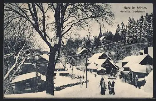 AK Schierke /Harz, Dorfstrasse mit Schlittenfahrer im Winter