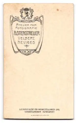 Fotografie H. Ottenstreuer, Velbert, Kleines Kind im Rüschenkleid mit Blume in der Hand