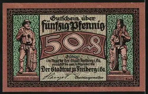 Notgeld Freiberg, 50 Pfennig, Arbeiter schiebt Kohlenwagen und Stadtwappen mit zwei Figuren