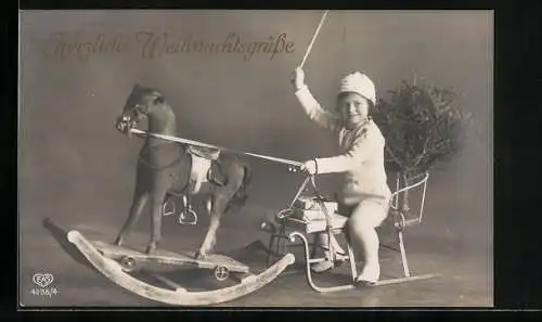 AK Kleines Kind auf Schlitten mit Schaukelpferd, Weihnachtsgruss