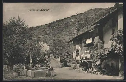 AK Klausen, Strassenpartie am Brunnen