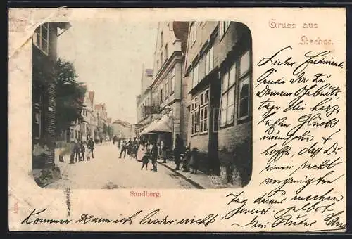 AK Itzehoe, Strasse Sandberg mit Geschäftshaus und kleiner Versammlung