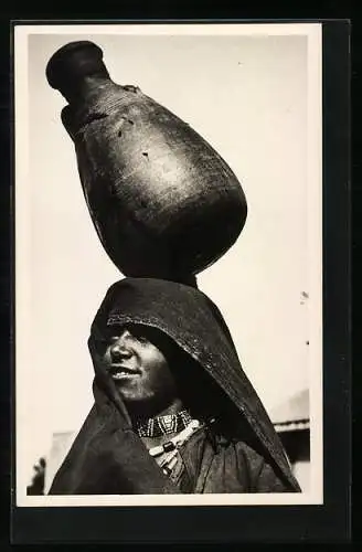 AK Arab woman with a jar of water