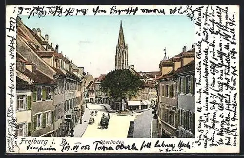 Goldfenster-AK Freiburg i. B., Oberlinden-Partie mit Blick zur Kirche