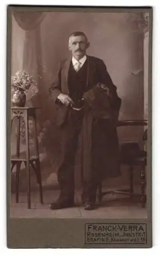 Fotografie Franck-Verra, Rosenheim, Innstrasse 1, Elegant gekleideter Herr mit Mantel in der Hand