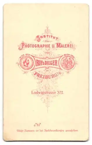 Fotografie Ruf & Dilger, Freiburg, Ludwigstrasse 2, Zwei Kinder in Sonntagskleidung auf elegantem Sessel
