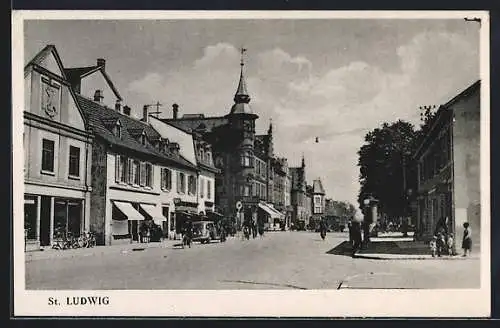 AK St. Ludwig, Strassenpartie mit Abzweig, Geschäften und Turmgebäude