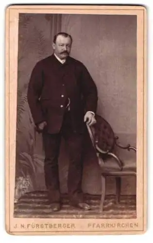 Fotografie J. N. Fürstberger, Pfarrkirchen, Portrait eines Mannes mit Schnurrbart und Stuhl