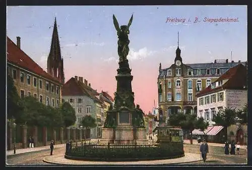 AK Freiburg i. B., Siegesdenkmal mit Strassenbahn