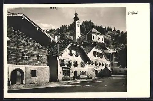 AK Grossarl, Ortspartie mit Geschäften und Blick zur Kirche