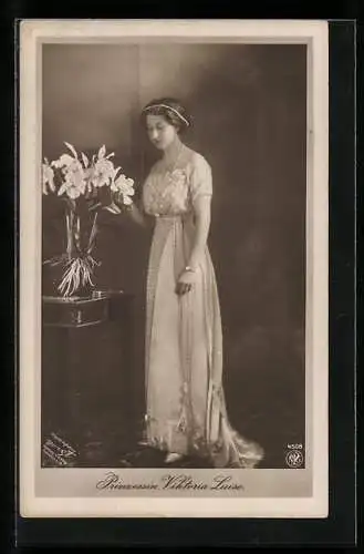 AK Prinzessin Viktoria Luise von Preussen im schönen Kleid, posierend an einem Blumenstrauss