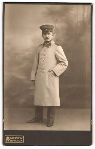 Fotografie A. Wertheim, Berlin, Soldat Willy in Uniform mit Mantel und Schirmmütze