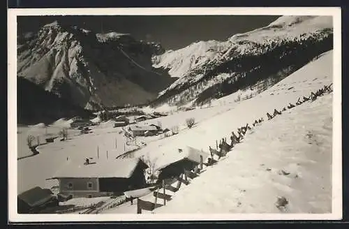 AK Obernberg am Brenner, Verschneite Ortsansicht in den Bergen