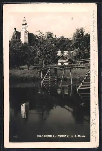 AK Hartkirchen /O.-Oe., Hilkering, Flusspartie mit Holzbrücke und Kirche