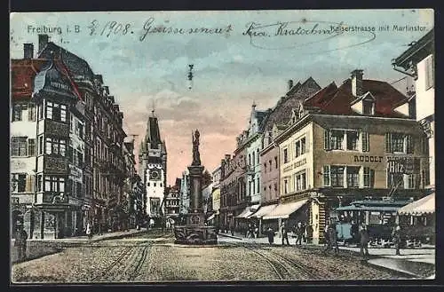 AK Freiburg i. B., Kaiserstrasse mit Geschäften, Martinstor und Brunnen