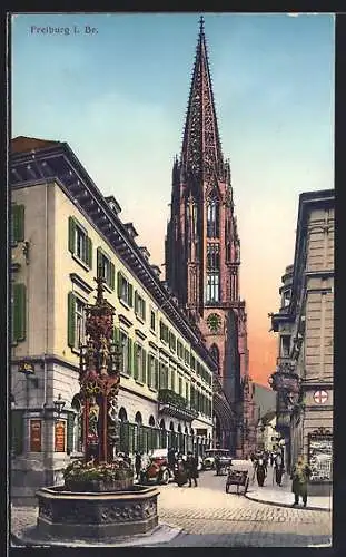 AK Freiburg i. Br., Münsterstrasse mit Kirche und Brunnen