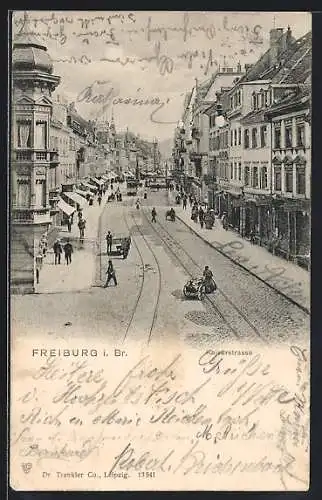 AK Freiburg i. Br., Kaiserstrasse mit Geschäften und Strassenbahn