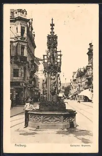 AK Freiburg / Breisgau, Mann am Gotischen Brunnen