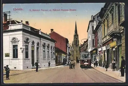 AK Ujvidék, Rakoczi Ferencz Strasse mit Abzweig, Kirche und Strassenbahn