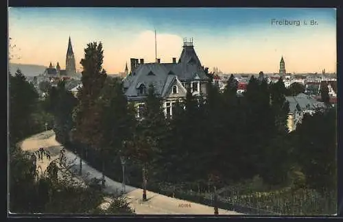 AK Freiburg i. Br., Teilansicht mit Kirche und Strassenpartie