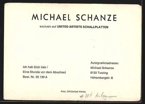 AK Musiker Michael Schanze sitzt lächelnd auf dem Boden, mit Autograph