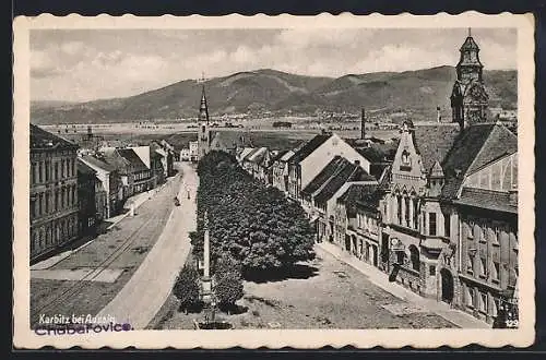 AK Karbitz bei Aussig, Strassenpartie mit Kirche