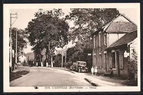 AK L`Aiguille, Vue de la rue principale avec bâtiments et voiture