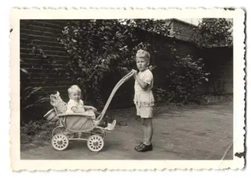 Fotografie Knabe schiebt Baby im Kinderwagen umher, Görlitz 1935