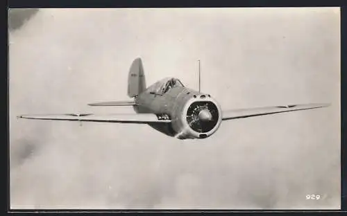 AK Military Aircraft in front of a cloud