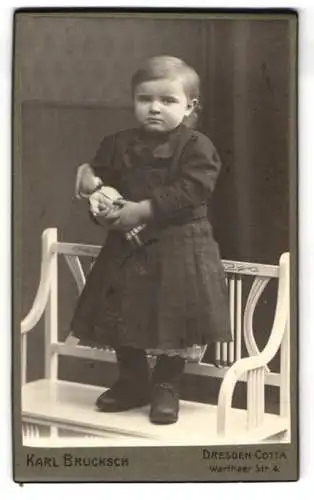 Fotografie Karl Bruksch, Dresden-Cotta, Warthaer-Str. 4, Mädchen mit Puppe auf Bank stehend