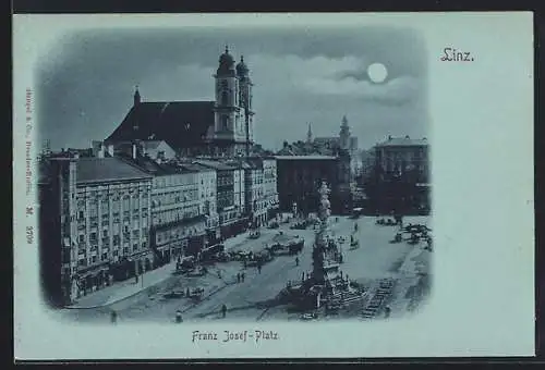 Mondschein-AK Linz, Franz Josefs-Platz mit Denkmal und Geschäften