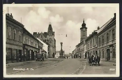 AK Zistersdorf /N. Oe., Strassenpartie mit Handlung Leopold Frank und Pestsäule