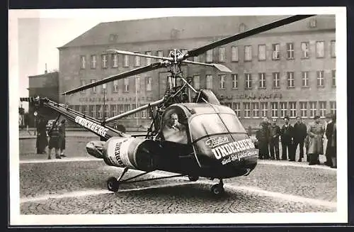 AK Hubschrauber mit Reklame für dioe Firma Underberg, die fliegende Underberg-Flasche mit Pilot Sepp Bauer